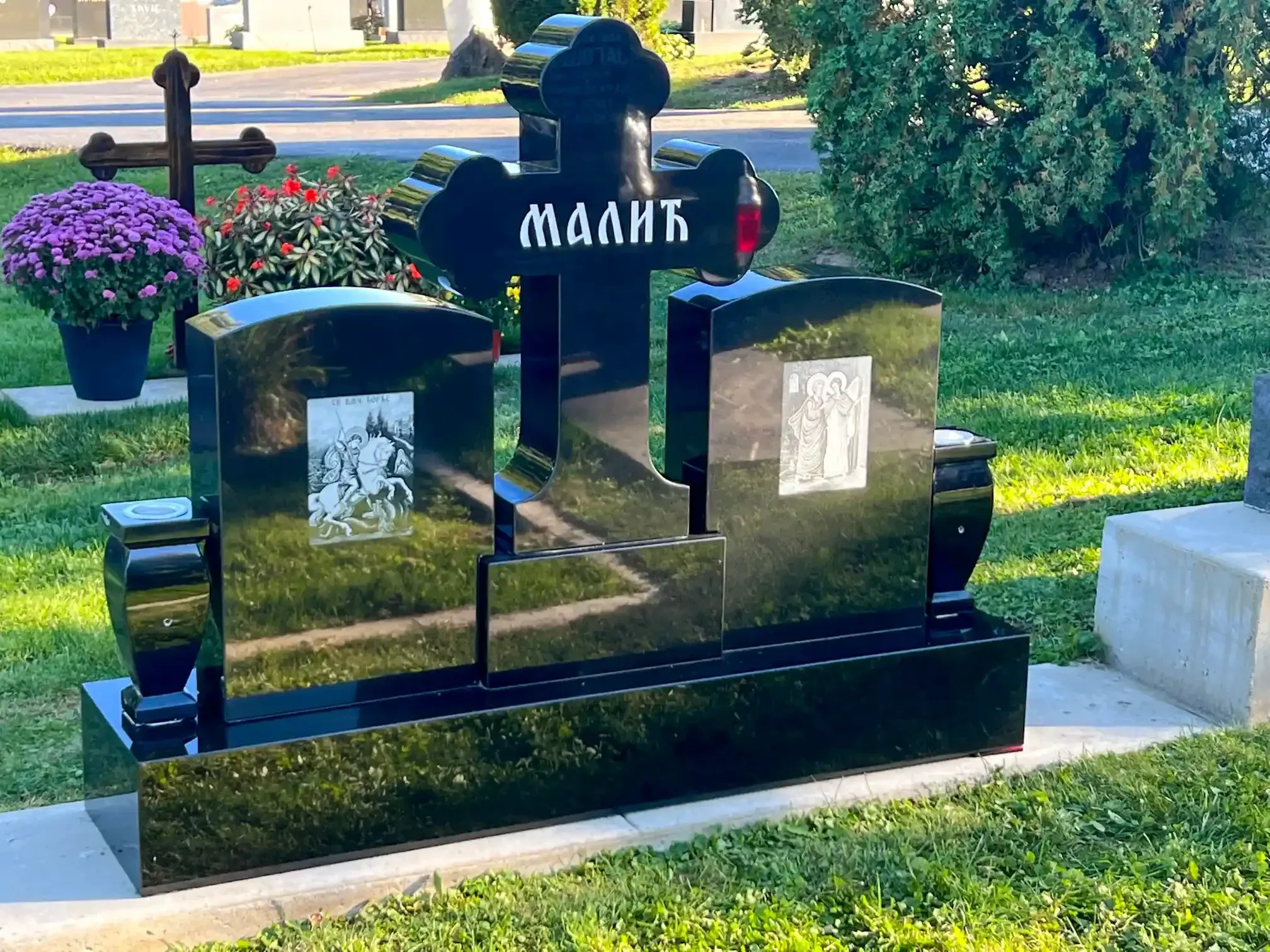 Memorial monuments and markers displayed in a serene outdoor setting