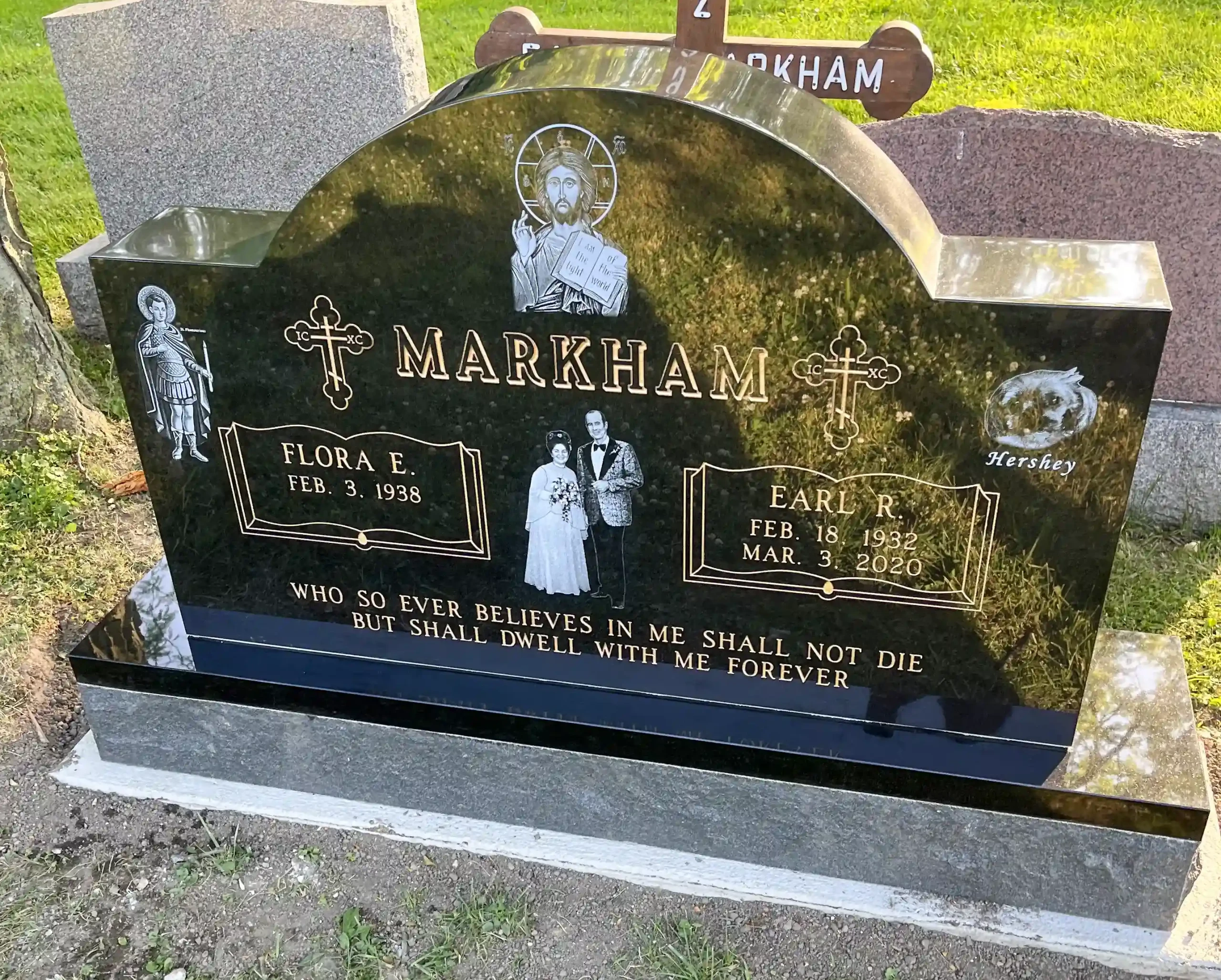 Beautiful black granite headstone with laser engravings and gold lettering.